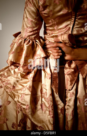 Renaissance woman holding a knife behind her back Stock Photo