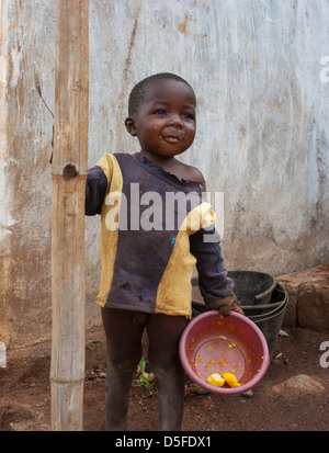 African child eating in Cameroon with bowl and spoon Stock Photo