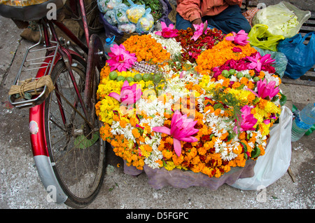 various colorful  flowers religious offerings in Varanasi street market, India Stock Photo