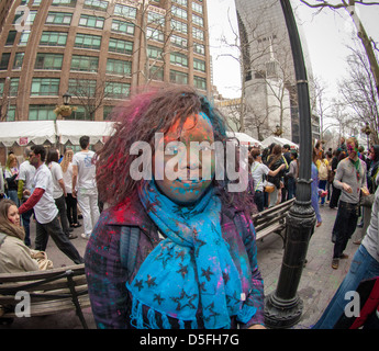 Colored powder is applied to the faces of participants as they celebrate the Indian holiday of Holi Stock Photo