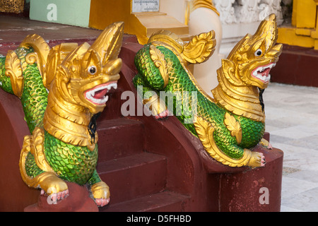 Two mythological statues at Shwedagon Pagoda, Yangon (Rangoon), Myanmar, (Burma) Stock Photo