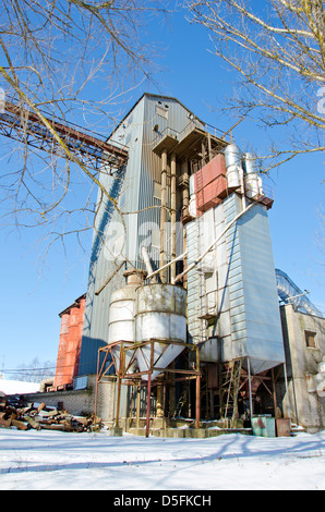 industrial grain Processing Facility in winter time. Cereal factory Stock Photo