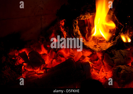 Flames burning paper down to embers Stock Photo