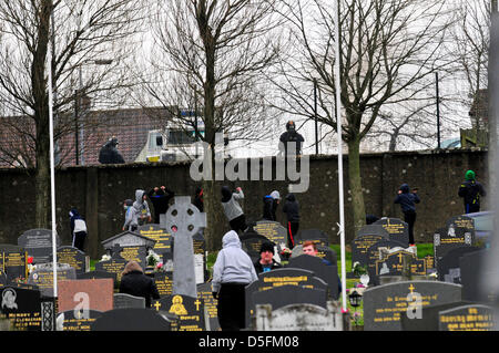Londonderry, UK. 1st April, 2013. Youths attack a PSNI officers at a 32 County Sovereignty (32 CSM) commemoration, in the City Cemetery, to mark the 97th  anniversary of the 1916 Easter Rising. Credit: George Sweeney/Alamy Live News Stock Photo