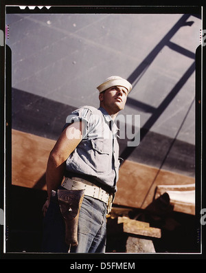 Coast Guardsman standing watch over 78-foot torpedo boat. Continual watch is kept. Higgins Industries, Inc., New Orleans, La. (LOC) Stock Photo