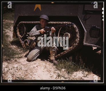 A young soldier of the armored forces holds and sights his Garand rifle like an old timer, Fort Knox, Ky. He likes the piece for its fine firing qualities and its rugged, dependable mechanism. Infantryman with halftrack (LOC) Stock Photo