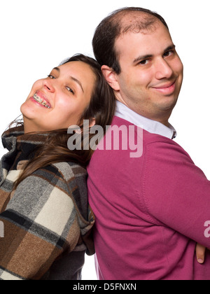 Smiling happy couple back to back isolated on white background Stock Photo