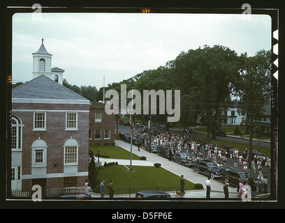 An American town and its way of life, Southington, Conn. The Memorial Day parade moving down the main street. The small number of spectators is accounted for by the fact that the town's war factories did not close. The town hall is in the left foreground. Stock Photo