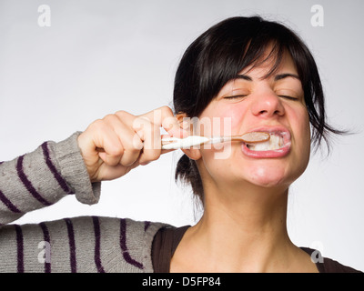 Young woman brushing her teeth Stock Photo