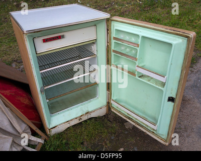 Old fridge abandoned on the sidewalk Stock Photo