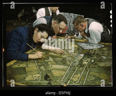 Camouflage class in New York University, where men and women are preparing for jobs in the Army or in industry, New York, N.Y. They make models from aerial photographs, re-photograph them, then work out a camouflage scheme and make a final photograph (LO Stock Photo
