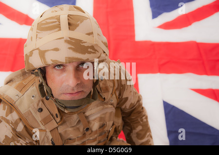 Elevated view of a British soldier with a Union Jack flag background. Stock Photo