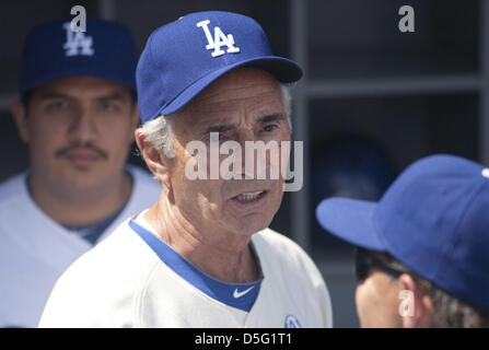 Former Los Angeles Dodgers pitcher Fernando Valenzuela greets Mike Scioscia,  standing, during his jersey retirement ceremony before the baseball game  between the Dodgers and the Colorado Rockies, Friday, Aug. 11, 2023, in