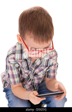 Clever small boy plays with his touch smartphone isolated on white background Stock Photo