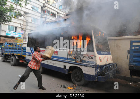 Dhaka, Bangladesh. April 2, 2013.  Bangladeshi local people try to dose a bun bus, a protest set fire on the during a nationwide strike called by the opposition Bangladesh Nationalist Party (BNP) and its allies in old Dhaka on April 02, 2013. The BNP and its allies Jamaat-e-Islami and its student wing Islami Chhatra Shibir enforced a down to dusk general strike across the country mainly to demand the release of their leaders and activists detained earlier this week. Credit Image: Credit:  Monirul Alam/ZUMAPRESS.com/Alamy Live News Stock Photo