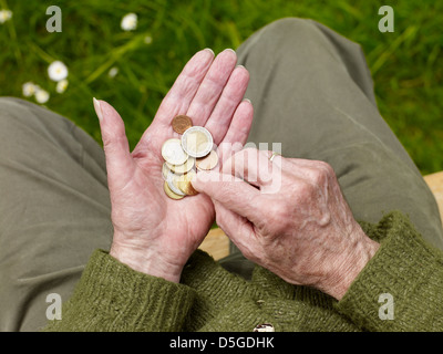hands of a senior counting less money, poverty Stock Photo