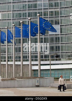 Woman carrying two bags at the Berlaymont building of the European Commission in Brussels, Belgium
