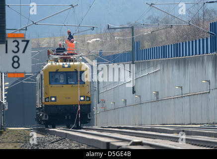 Workers of the German railways repair the overhead wire in front of the Niedernhausen tunnel near Niedernhausen-Niederseelbach, Germany, 02 April 2013. An ICE got stuck in a tunnel between Frankfurt and Cologne with 450 passengers. According to first presumptions a bird had flown into the tunnel and caused a short circuit. The passengers had to wait four hours in the train before they could change onto another train. Photo: ARNE DEDERT Stock Photo