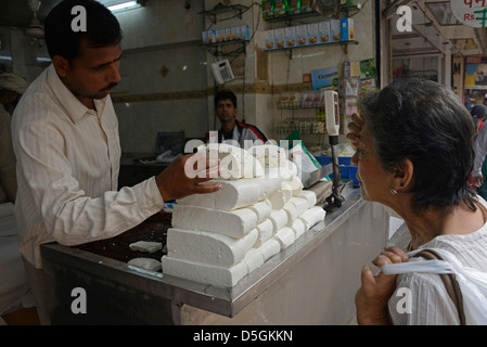 A local Delhi customer enquiring about a price of an Indian Paneer cheese known as Ponir or Indian cottage cheese, on sale in Chandni Chowk, a history Stock Photo