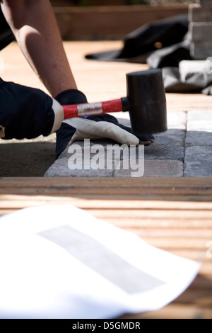 Building a patio with wooden terrace and stones Stock Photo