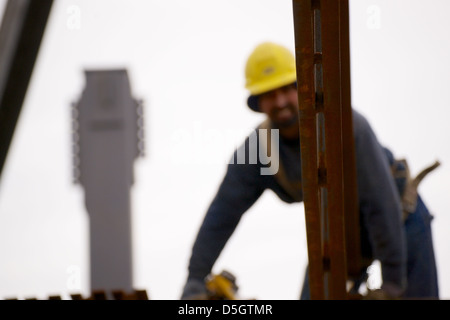 Ironworker connecting steel beams during construction of a building ...