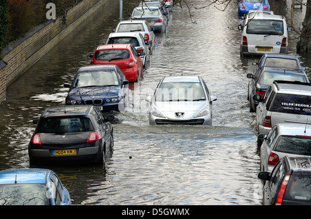 Parked cars in flooded suburban road London