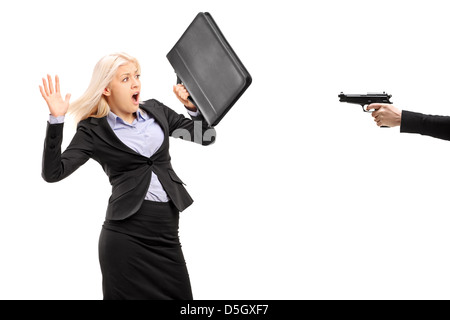 Afraid businesswoman from a gun isolated on white background Stock Photo
