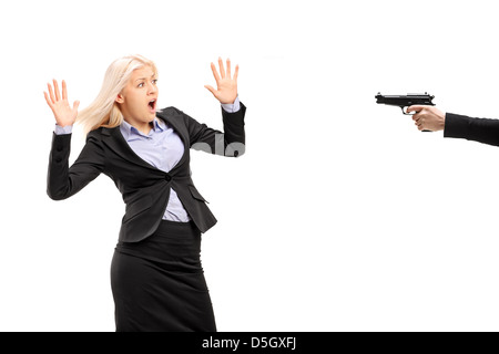 Afraid young businesswoman from a gun isolated on white background Stock Photo