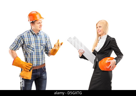 Male manual worker having a conversation with female architect, isolated on white background Stock Photo