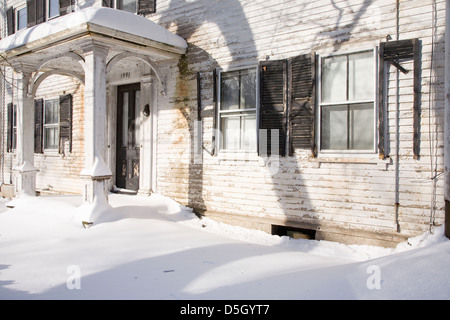 Rundown haunted home with snow and ice cycles, Ma., New England, USA Stock Photo