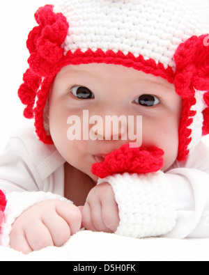 baby with knitted white hat baby on stomach Stock Photo