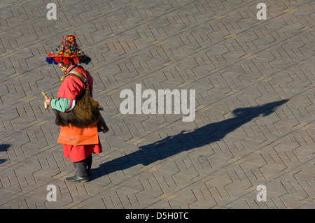 Traditional water-carrier dressed in red in the Djemaa el-Fna square, Marrakech, Morocco Stock Photo