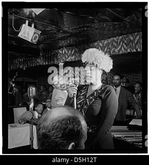 This 1947 photograph features jazz legends Ella Fitzgerald, Dizzy Gillespie, Ray Brown, Milt Jackson, and Timmie Rosenkrantz, captured in a moment at Downbeat, New York. This historic image reflects their significant contributions to the jazz genre. Stock Photo