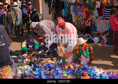 Madagascar, Ambositra, Marche Sandrandahy market, customers at shoe stall Stock Photo