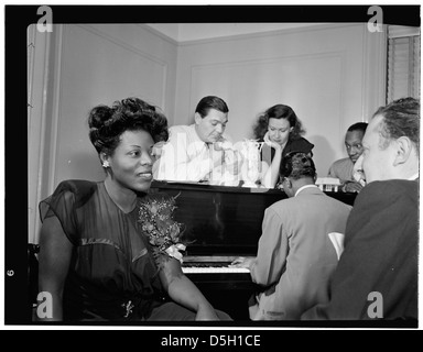 [Portrait of Dizzy Gillespie, Mary Lou Williams, Tadd Dameron, Hank Jones, Milt Orent, Dixie Bailey, and Jack Teagarden, Mary Lou Williams' apartment, New York, N.Y., ca. Aug. 1947] (LOC) Stock Photo