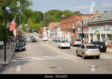 Storefronts in historic Concord, MA on Memorial Day Weekend with American Flags displayed Stock Photo