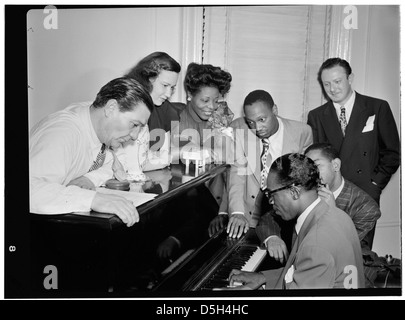 [Portrait of Jack Teagarden, Dixie Bailey, Mary Lou Williams, Tadd Dameron, Hank Jones, Dizzy Gillespie, and Milt Orent, Mary Lou Williams' apartment, New York, N.Y., ca. Aug. 1947] (LOC) Stock Photo