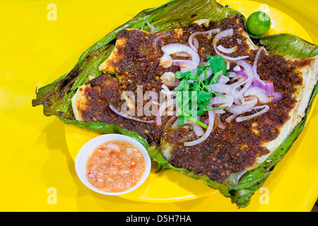 Stingray Fish with Sambal Chili Paste Sauce with Chopped Onions Cilantro and Fermented Shrimp Dipping Sauce Stock Photo