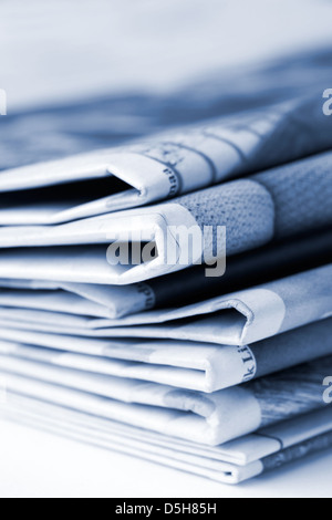 Folded newspapers on brown wooden table Stock Photo