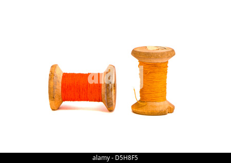 old grunge two wooden  thread spools isolated on white Stock Photo