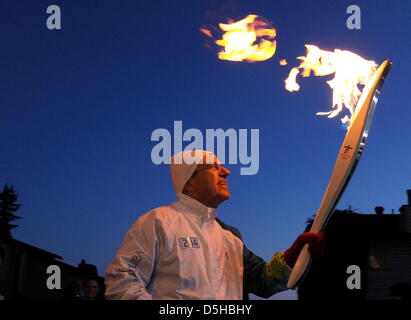 Torchbearer Thomas Bach, president of the German NOC and IOC vice-president, carries the Olympic Flame through Surrey, Canada, 07 February 2010, enroute to Vancouver 2010 Olympic Games. Canada's third biggest city will host the 2010 Winter Olympic Games from February 12 - 28 February 2010. Photo: Arne Dedert  +++(c) dpa - Bildfunk+++ Stock Photo