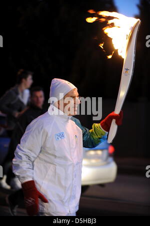 Torchbearer Thomas Bach, president of the German NOC and IOC vice-president, carries the Olympic Flame through Surrey, Canada, 07 February 2010, enroute to Vancouver 2010 Olympic Games. Canada's third biggest city will host the 2010 Winter Olympic Games from February 12 - 28 February 2010. Photo: Arne Dedert  +++(c) dpa - Bildfunk+++ Stock Photo