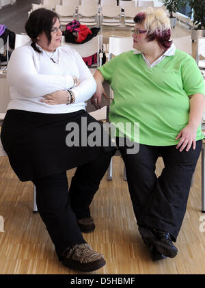 Two 26-year-old women Nicole (R) and Ivonne (L) sit together in the waiting area at the clinic for internal medicine of University Leipzig, Germany, dated 13 January 2010. Both of the women belong to a group of patients who suffer of adiposity (obesity), which has been treated for several years at the clinic. During the next weeks, an integrated research and treatment center for ad Stock Photo
