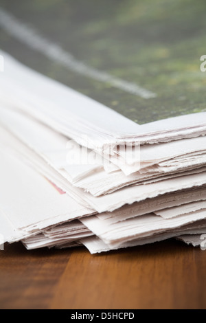 Folded newspapers on brown wooden table Stock Photo