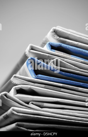 Folded newspapers on brown wooden table Stock Photo