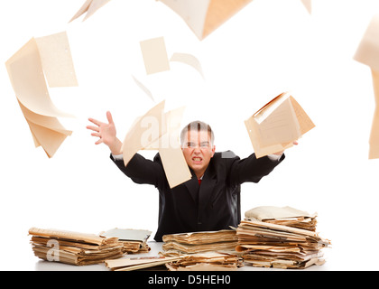 Angry business man throwing away lots of paperwork Stock Photo