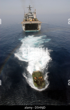 A US Navy amphibious assault vehicle departs the well deck of the amphibious dock landing ship USS Rushmore during an exercise Mar. 29, 2013 in the Arabian Sea. Green Bay is part of the Peleliu Amphibious Ready Group and, with embarked 15th Marine Expeditionary Unit, is deployed in support of maritime security operations and theater security cooperation efforts in the U.S. 5th Fleet area of responsibility. Stock Photo