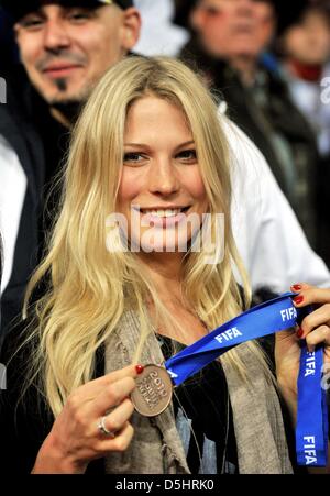 Sarah Brandner, girlfriend of German player Bastian Schweinsteiger, poses in the stands with the bronze medal of Schweinsteiger after the 2010 FIFA World Cup third place match between Uruguay and Germany at the Nelson Mandela Bay Stadium in Port Elizabeth, South Africa 10 July 2010. Photo: Bernd Weissbrod dpa - Please refer to http://dpaq.de/FIFA-WM2010-TC  +++(c) dpa - Bildfunk+++ Stock Photo