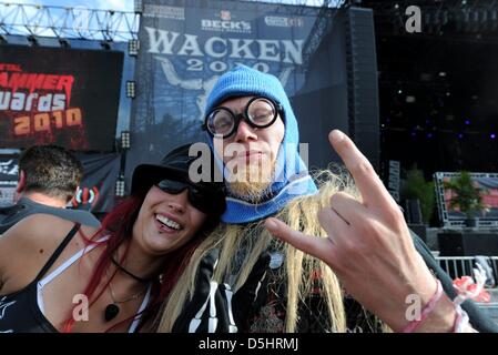 Visitors of the 'Wacken Open Air festival' appear cheerful on the festival area in Wacken, Schleswig-Holstein, Germany, 5 August 2010. More than 75.000 'Metalheads' are expected at the worlds largest Heavy Metal Festival situated in the town with 1800 inhabitants. Photo: Carsten Rehder Stock Photo