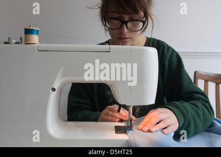 Creative Work Of Youth Exhibited In U.S. Cities -- Girls in high  (secondary) school learn to sew, and many design and make their own clothes.  This contestant, using an electric sewing machine